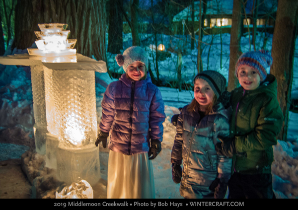 Three kids near the ice bar at Middlemoon Creekwalk 2019 Wintercraft