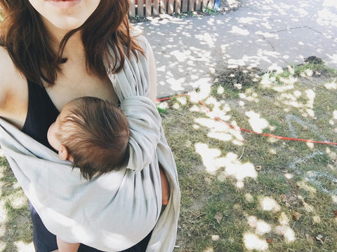 mother wearing baby in sling