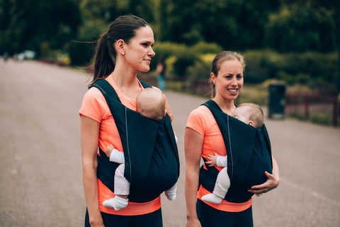 women wearing babies on their front