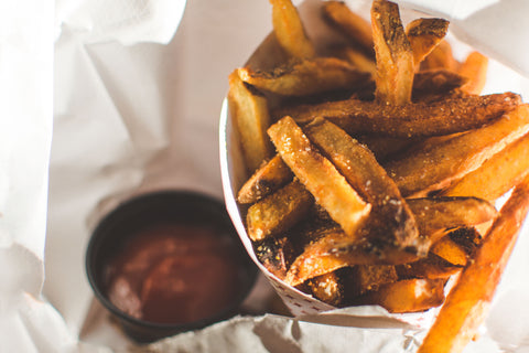 chips on white background with ketchup