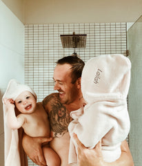 dad with daughters in shower bath time