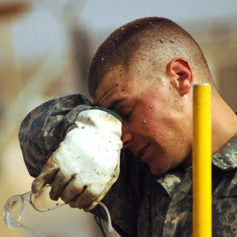 Man wiping sweat from brow