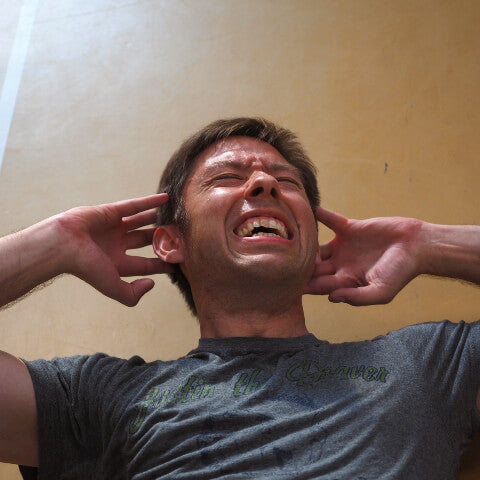 Man doing sit ups and perspiring