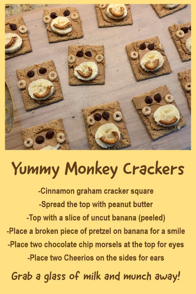 picture and receipe for graham crackers that look like monkey faces with peanut butter, chocalate chips, banana, cheerios and pretzal pieces.