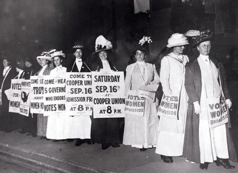 female suffragettes wearing white to a protest in the 1900's