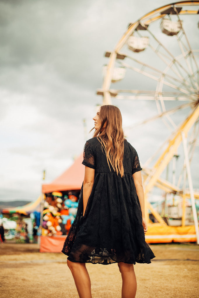 The black Ellie dress worn at a carnival