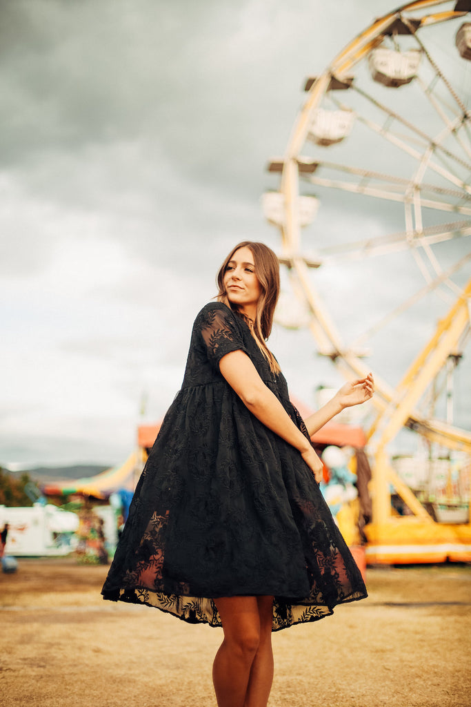 a Piper & Scoot model twirling in the black Ellie dress