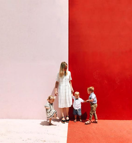 A mom wearing the Grid Dress while running around with her kids