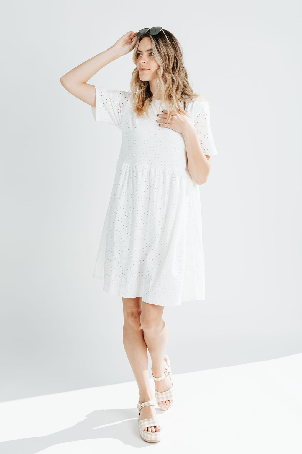 The Calloway Eyelet Detail Dress in White, studio shoot; front view