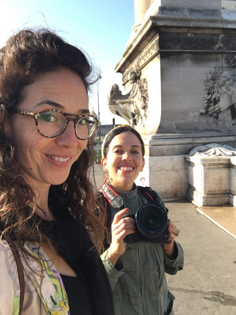 Hrissa the designer, and Violeta the photographer smiling together during the photo shoot in Paris.