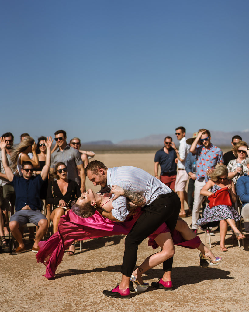 Jordan dips Kelsie in an epic kiss after they are officially married in the Mojave desert.