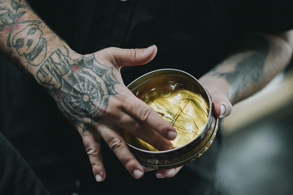 barber getting pomade from prospectors tin