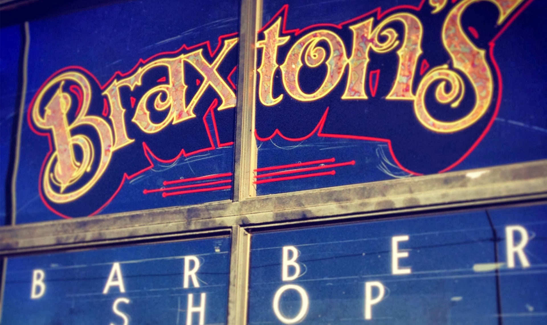 Braxton's Barber Shop window sign