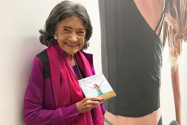 99-year-old yoga master Tao Porchon-Lynch holding her new book, Shining Bright -- November 18, 2017