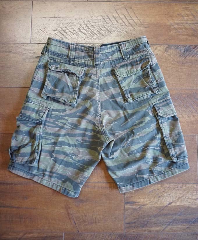 back side of rothco cargo camo shorts on the floor 