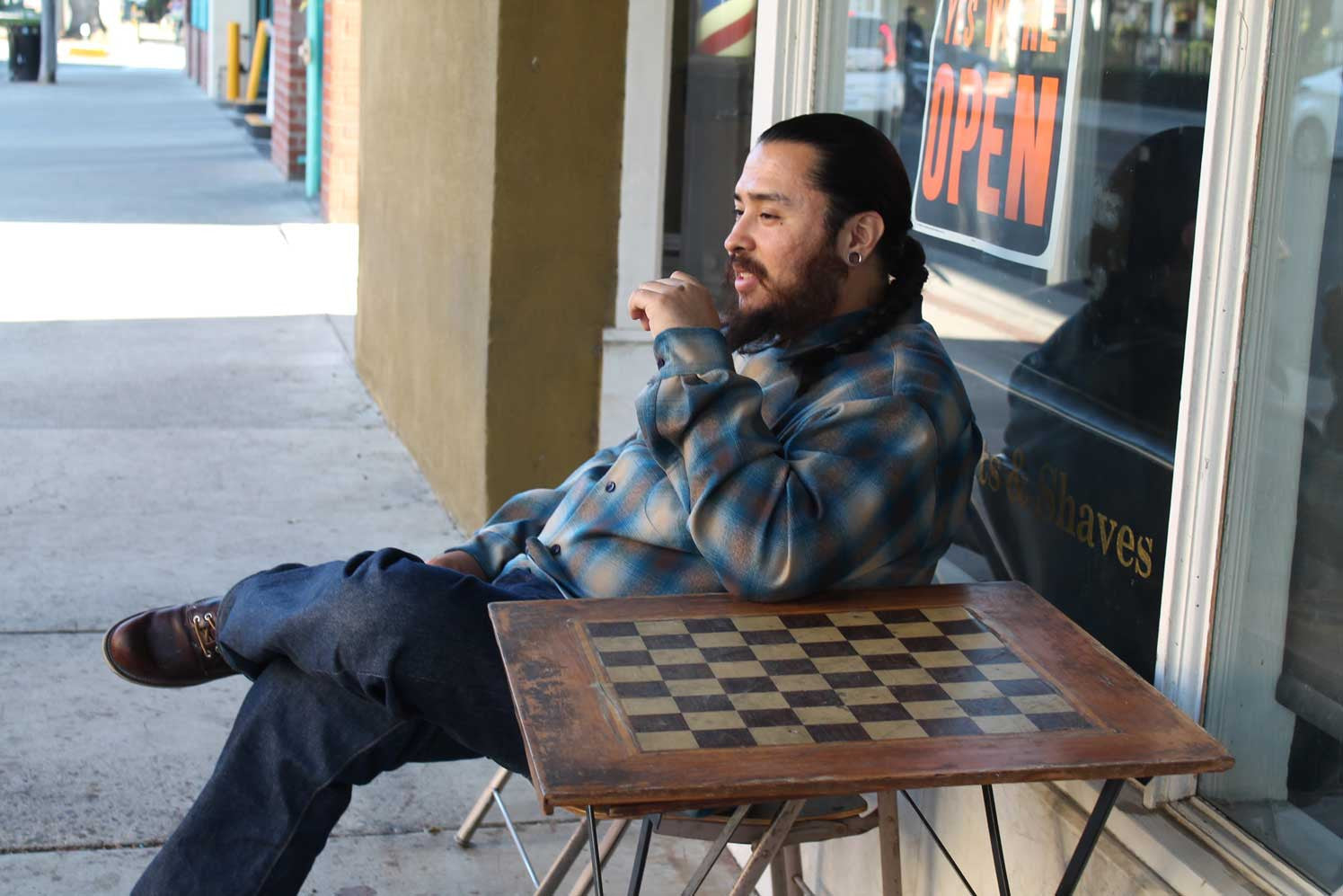 Adrian the barber wearing pendleton in front of barbershop for gunthers