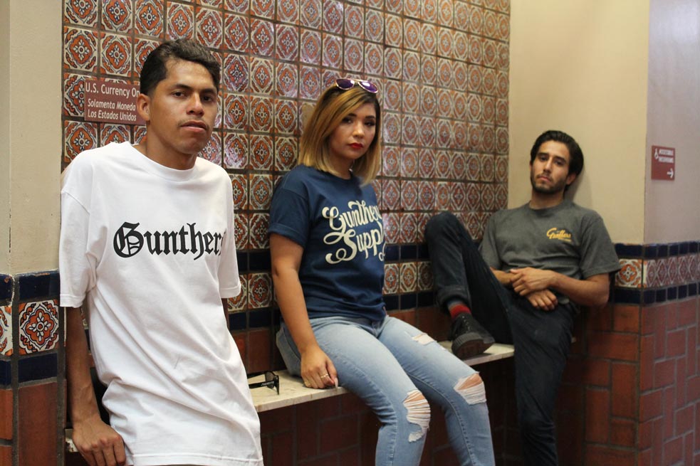 three-young-people-wearing-gunthers-t-shirts-looking-at-the-camera