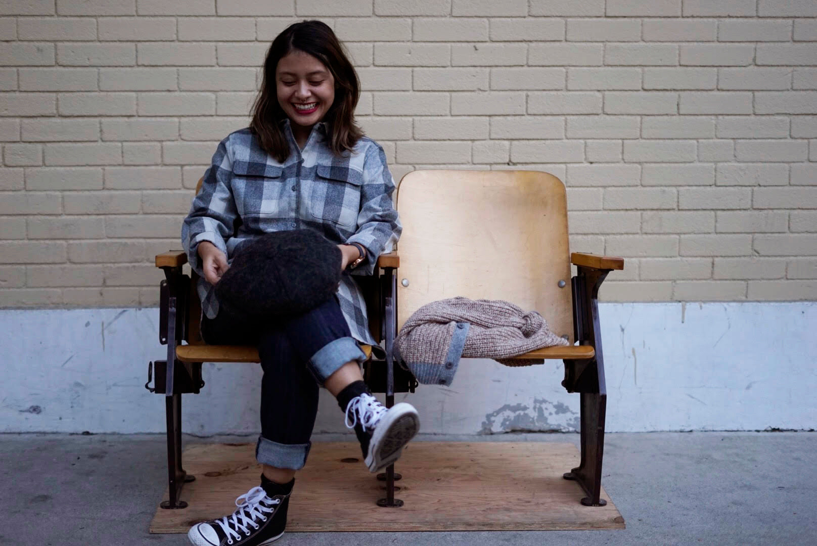 womans pendleton board shirt and sitting in a wooden barber chair