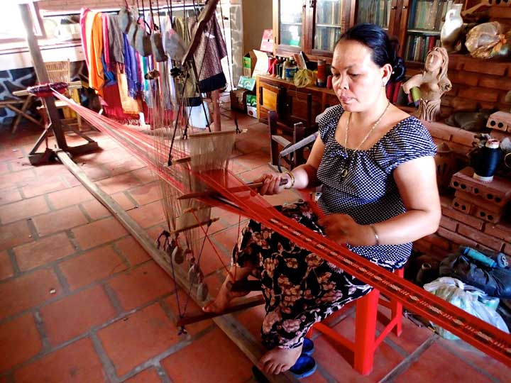 A Vietnamese artisan working on a handloom
