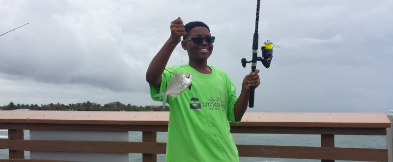 boy catches sand perch pier fishing with shark zen