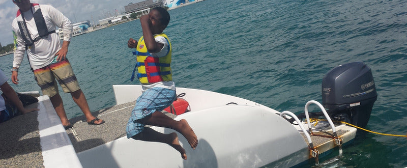 boy jumping in water - ffa shark zen kids fishing trip