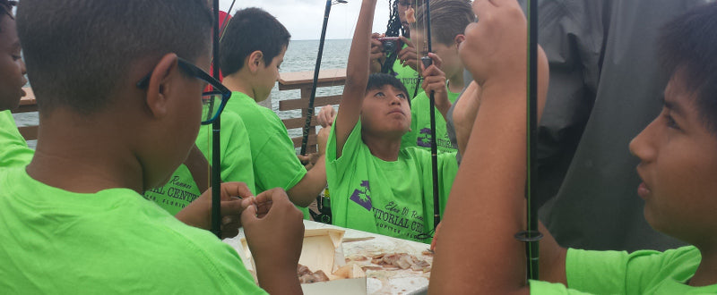 kids baiting hooks while pier fishing with shark zen