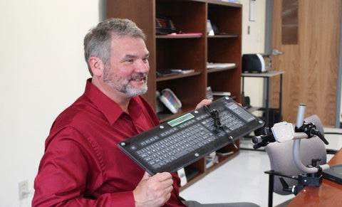 Glen Dobbs demonstrating the new waterproof keyboard with the EASTCONN Assistive Technology team