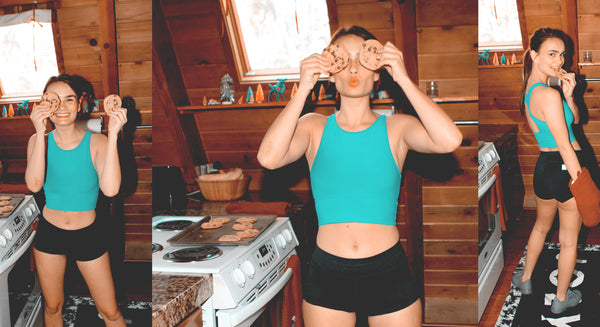 Girl Holding Cookies Over Face Wearing Activewear