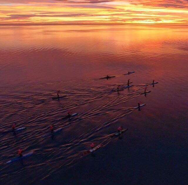 paddle boarders in blue water