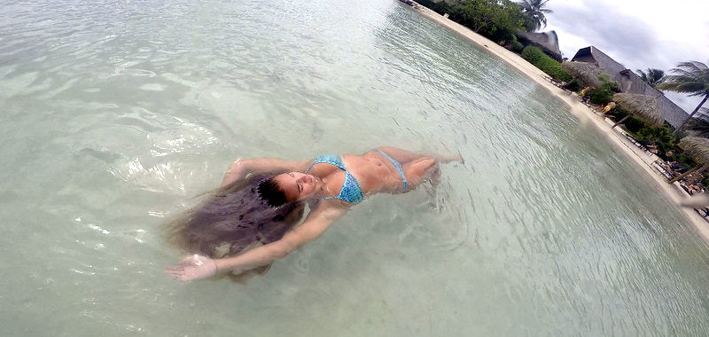 Eryn Krouse on a canoe in a JOLYN bikini