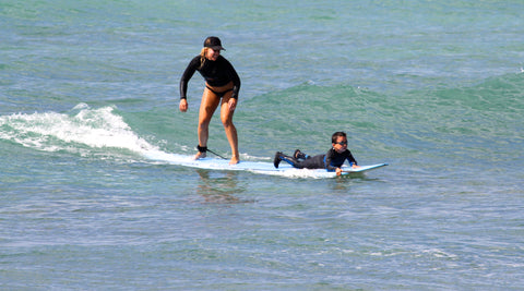 JOLYN'S Robin Lang surfing with a small child