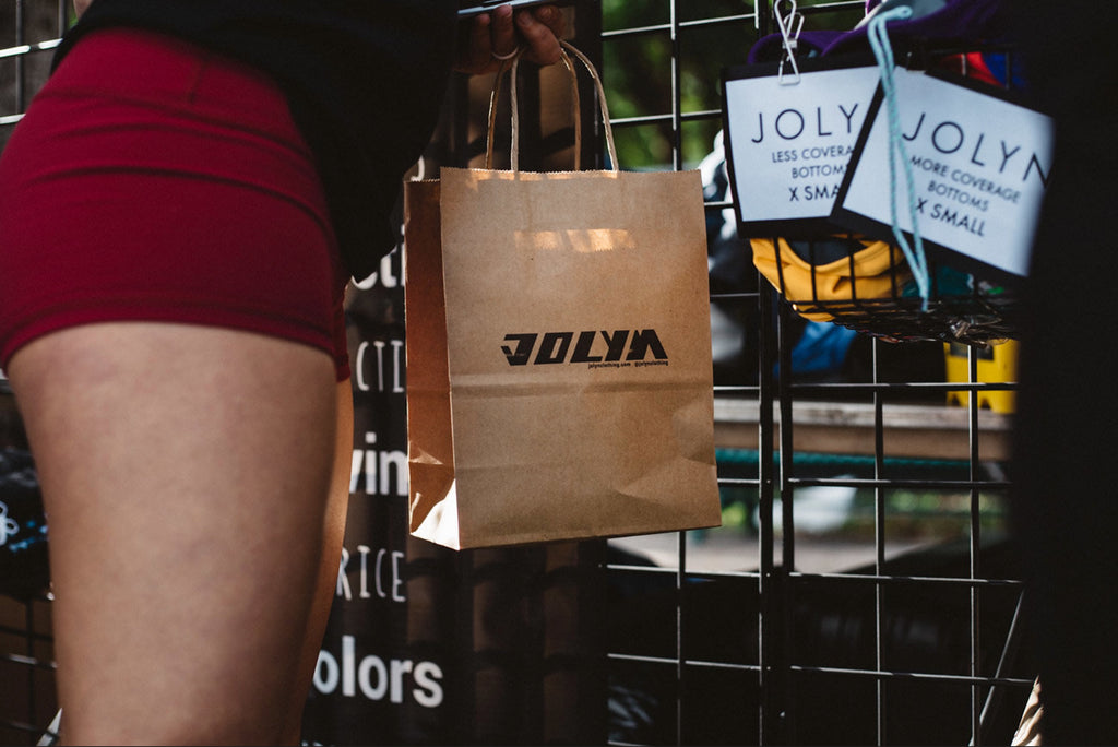 a women holding a JOLYN shopping bag