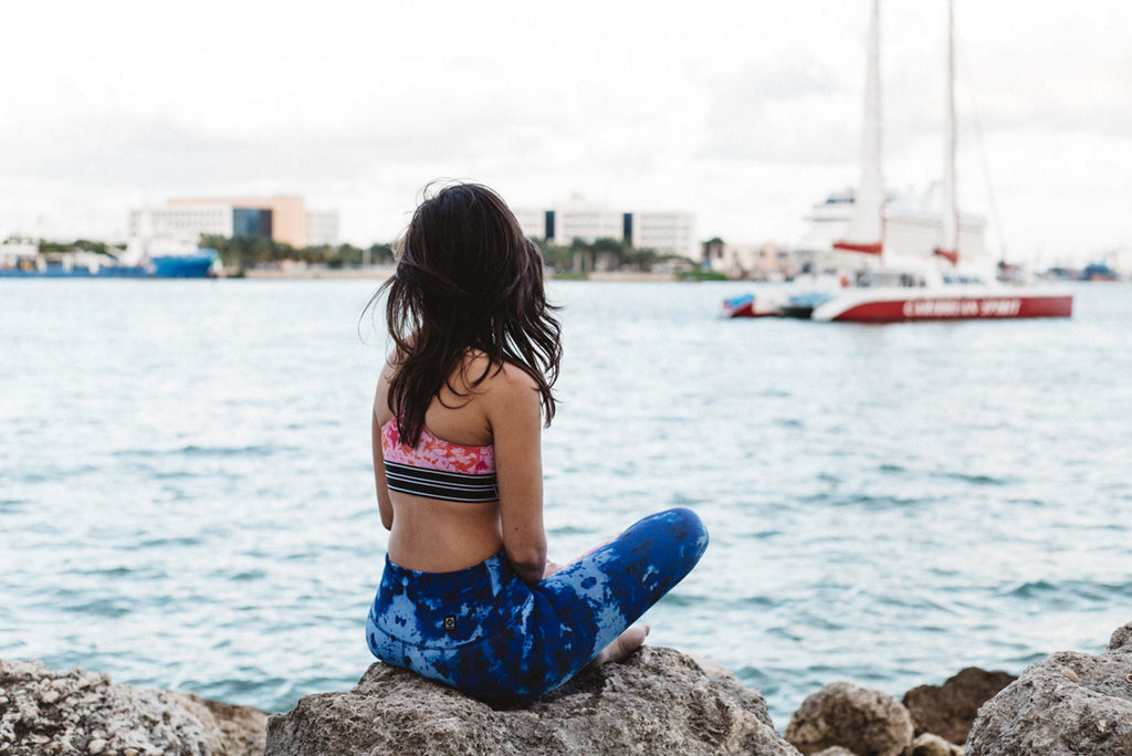 a woman wearing a JOLYN sports bra and leggings