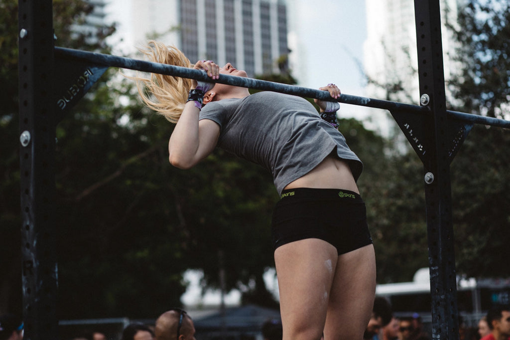 a woman doing a pull up