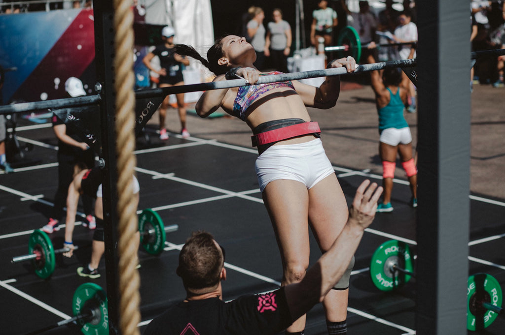 a woman doing a pull up