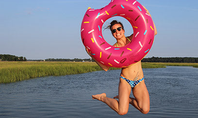 woman wearing a JOLYN bikini jumping in the water
