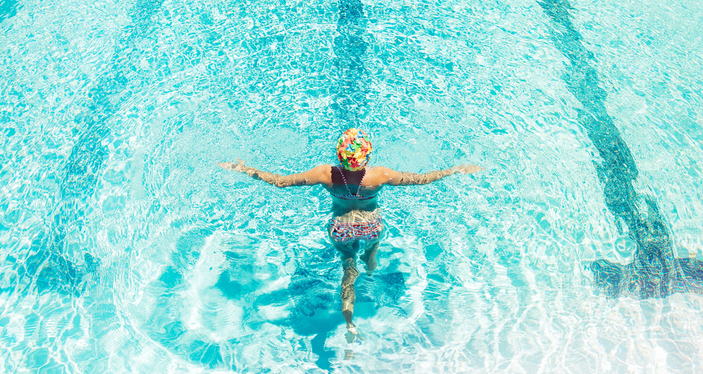 woman standing in a pool wearing a JOLYN bikini