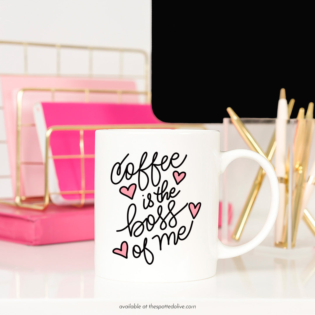 Coffee is the boss of me mug on desktop 