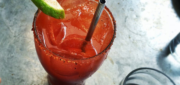 Craft beer cocktail, the Michelada or Mexican Bloody Mary made with Mexican lager, Clamato, lime juice and Tajin seasoning