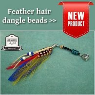 Single handmade feather dangle dreadlock hair bead displayed on aqua felt background