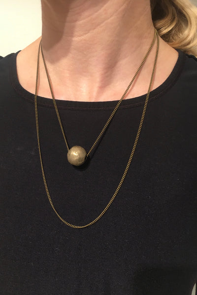 Layered brass globe necklace