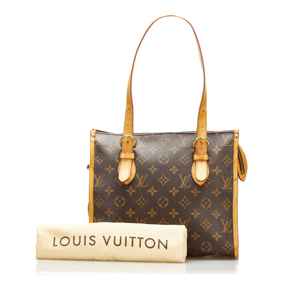 Porte-habits Louis Vuitton en toile monogram marron et cuir naturel.