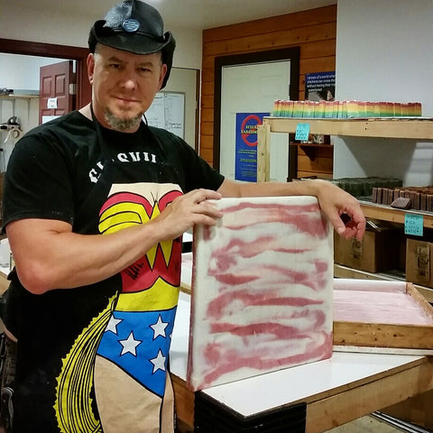 Russ holding a slab of Bacon Soap