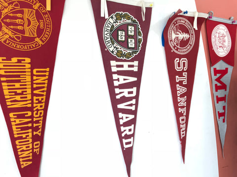 College pennants: USC, Harvard, Stanford, and MIT
