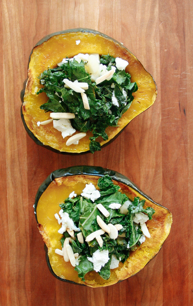 Acorn squash stuffed with kale, goat cheese, almonds, pear, cherry wood, cutting board, dinner, girls night