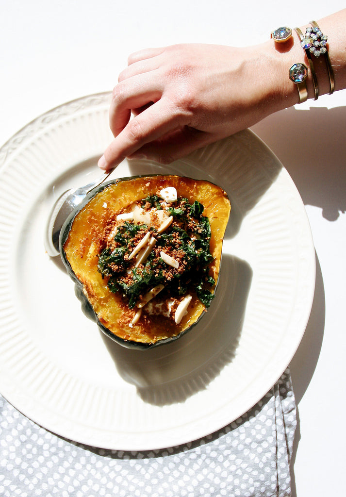 Acorn squash stuffed with kale, goat cheese, almonds, pear, bracelet, jewels, jewelry, crystal, plateware