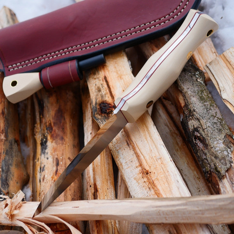 Adventure Sworn Classic bushcraft knife with a scandi grind and ivory paper micarta handle scales