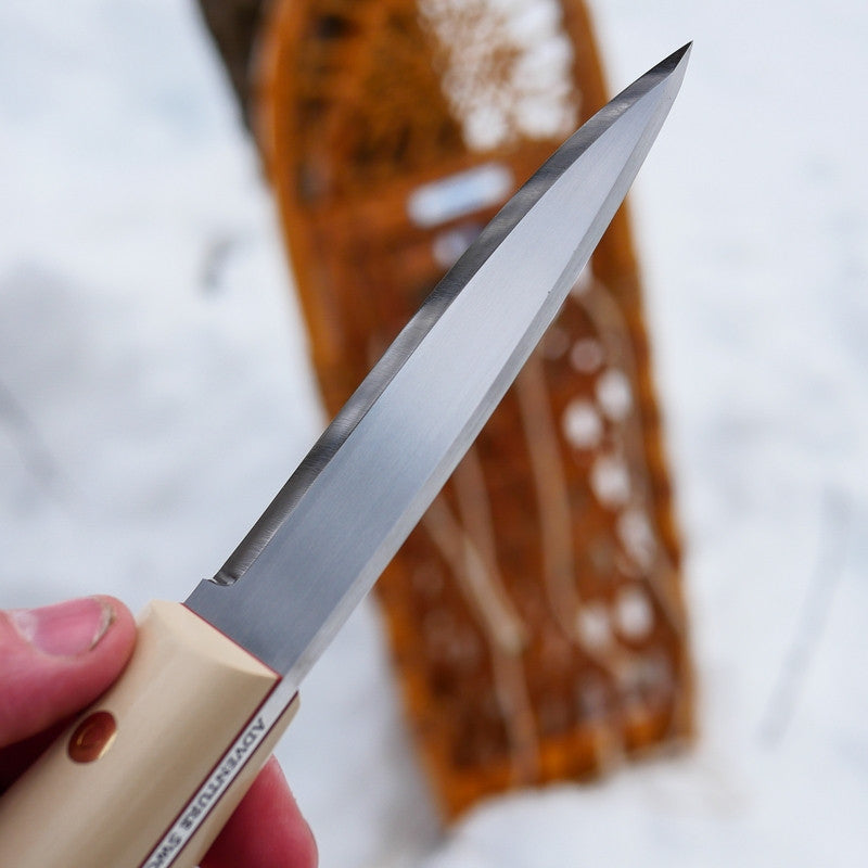 90 degree spine on an Adventure Sworn Classic bushcraft knife with a scandi grind and ivory paper micarta handle scales