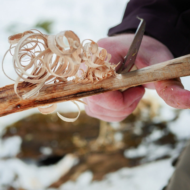 A scandi classic bushcraft knife making some feathersticks in the winter