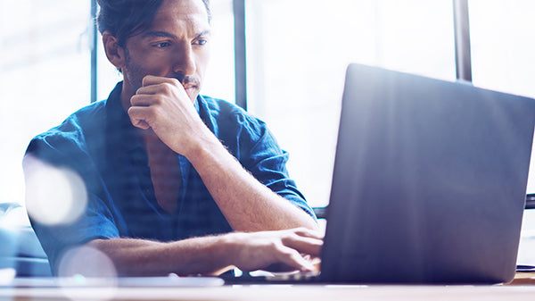 man looking at his laptop screen